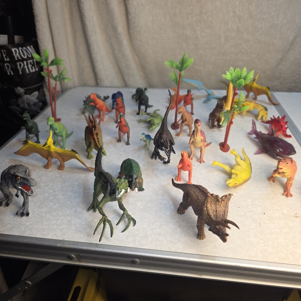 Lot of 32 dinosaur and prehistoric plastic toy figures, including carnivores,...